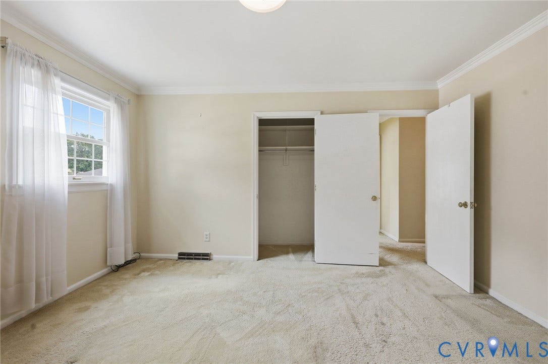 121 Huntington Road, Colonial Heights, VA 23834 Carpeted room featuring a single window, crown molding, and two white doors