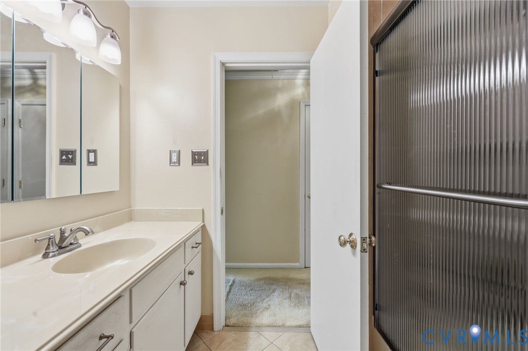 121 Huntington Road, Colonial Heights, VA 23834 Bathroom featuring a single vanity with an integrated sink, polished chrome faucet, and white cabinetry