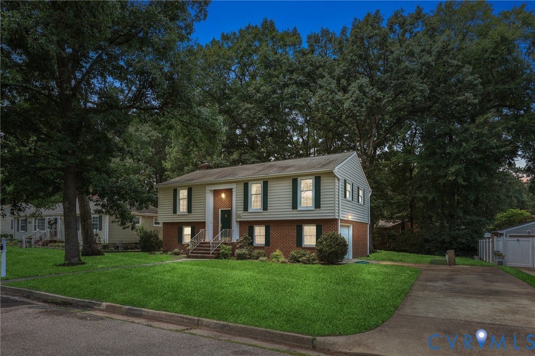 121 Huntington Road, Colonial Heights, VA 23834 Split-level residence featuring light-colored siding, dark green shutters, and a brick lower level