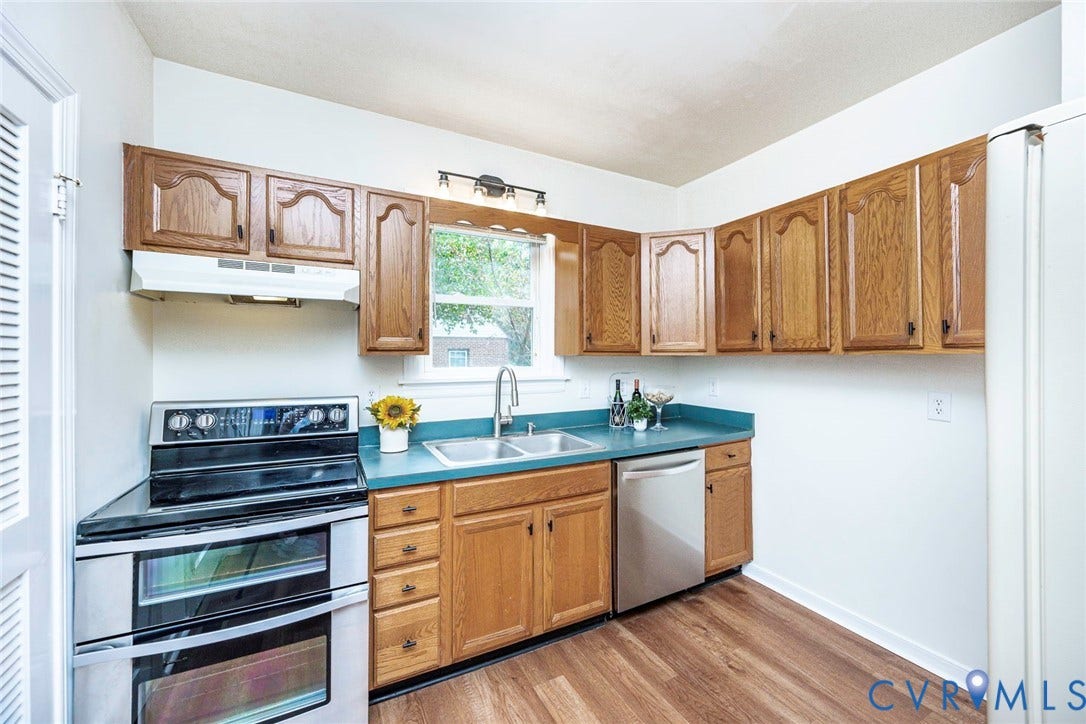 1402 Rhode Island Avenue, Glen Allen, VA 23060 Kitchen featuring wood-finish flooring, oak cabinetry, and a teal countertop