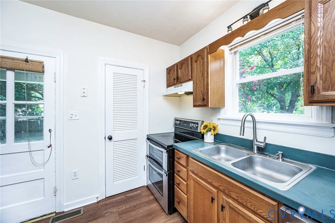 1402 Rhode Island Avenue, Glen Allen, VA 23060 Kitchen featuring a stainless steel double basin sink with a gooseneck faucet, wood-finish cabinetry, and a modern electric range