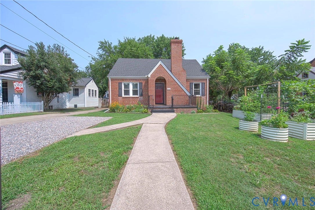 1402 Rhode Island Avenue, Glen Allen, VA 23060 Brick exterior with dark gray roof shingles, a prominent brick chimney, and a red front door