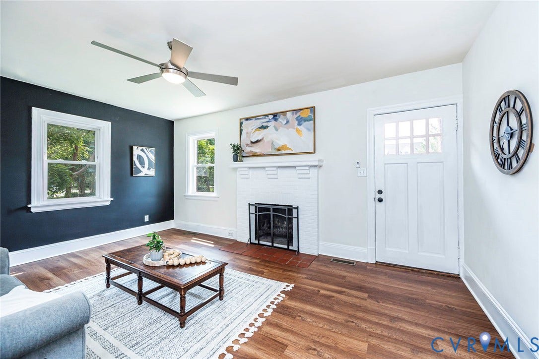 1402 Rhode Island Avenue, Glen Allen, VA 23060 Interior space featuring wood-finish flooring, a white fireplace with a dark grate, and a white entry door with glass panes