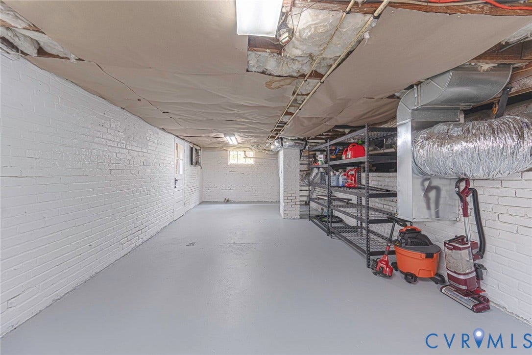 1402 Rhode Island Avenue, Glen Allen, VA 23060 Spacious unfinished basement featuring painted brick walls, a light gray concrete floor, and exposed ceiling joists