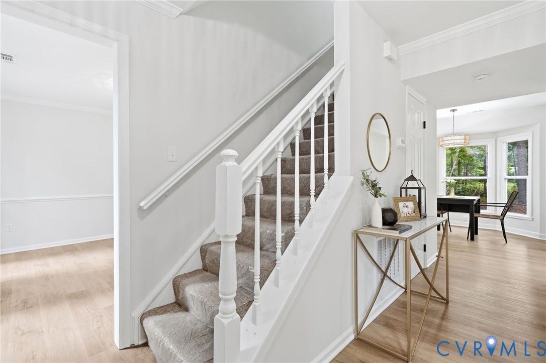 3700 Malbon Way, Chesterfield, VA 23832 Foyer featuring a carpeted staircase with white balusters and handrail, wood-finish flooring, and crown molding