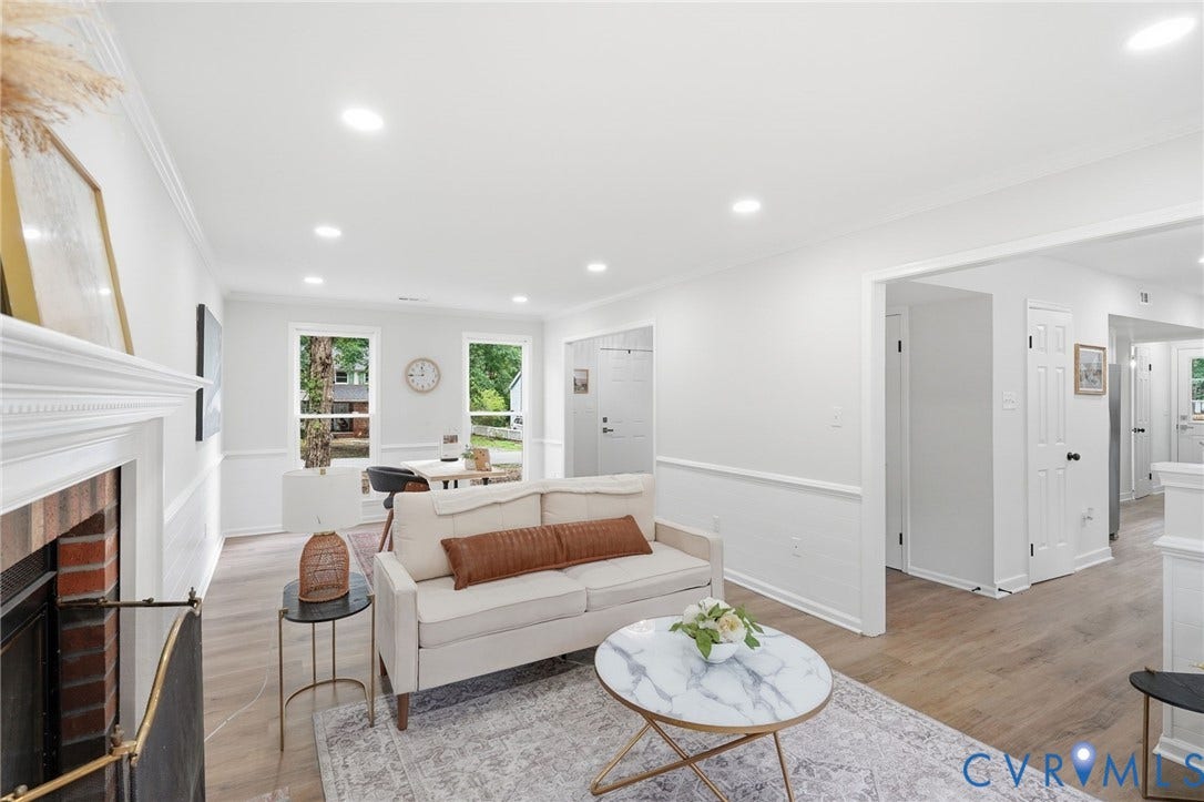 3700 Malbon Way, Chesterfield, VA 23832 Open-concept living area featuring light wood-finish flooring, recessed lighting, and a brick fireplace with a white mantel