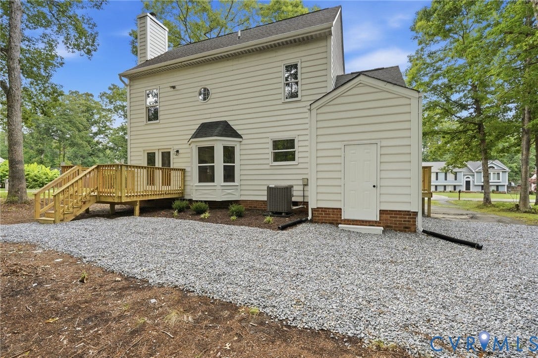 3700 Malbon Way, Chesterfield, VA 23832 Rear exterior featuring light-colored siding, a multi-level wood deck, a bay window, and an attached storage shed with brick foundation