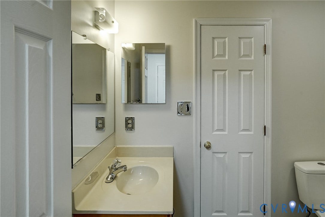 2221 High Bush Circle, Glen Allen, VA 23060 1st Floor Full Bathroom vanity with a light-colored countertop, integrated sink, and chrome faucet