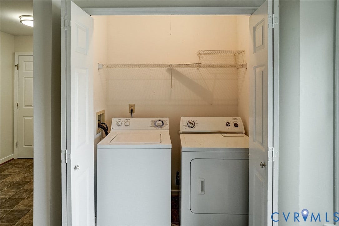 2221 High Bush Circle, Glen Allen, VA 23060 Dedicated laundry closet with bi-fold doors, equipped with a washer and dryer, and wire shelving for storage