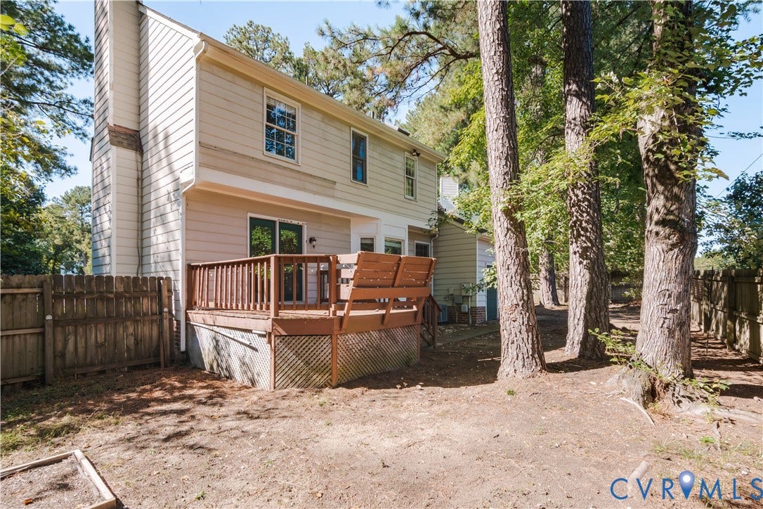 Rear yard is fully fenced with large deck with bench seating