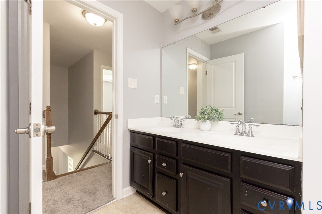 12814 Bailey Hill Court, Bayhill Pointe, Midlothian, VA 23112 Dual vanity with integral sinks, dark wood-finish cabinetry, and a full-width mirror
