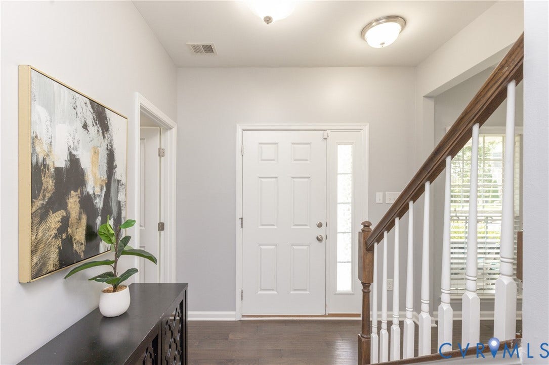 12814 Bailey Hill Court, Bayhill Pointe, Midlothian, VA 23112 Entryway featuring rich wood-finish flooring, a paneled door with a sidelight, and a staircase with white spindles and a wood handrail