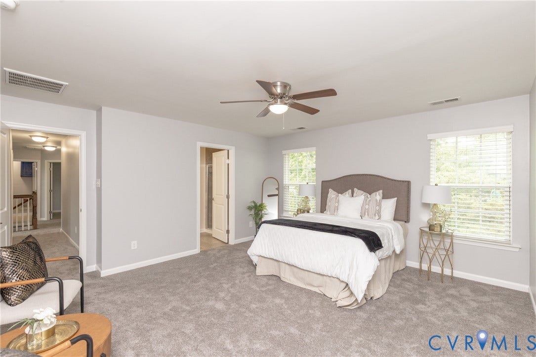 12814 Bailey Hill Court, Bayhill Pointe, Midlothian, VA 23112 Spacious room with gray carpeting, multiple windows providing natural light, a ceiling fan with light fixture, and light gray wall paint