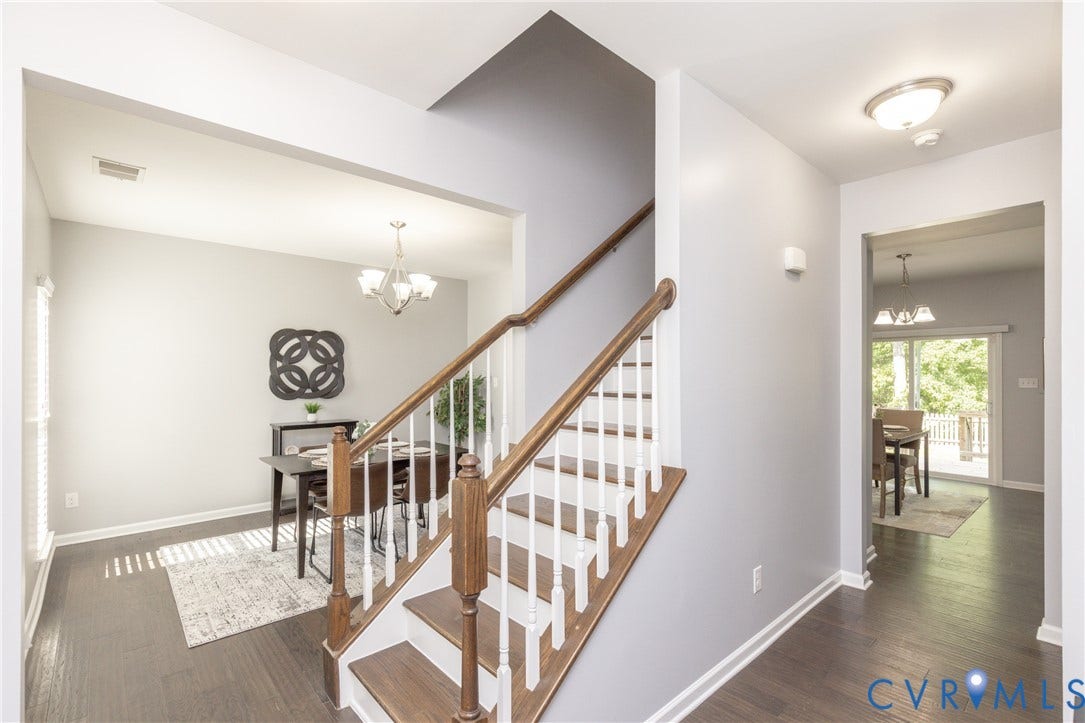 12814 Bailey Hill Court, Bayhill Pointe, Midlothian, VA 23112 Hardwood-finish flooring throughout, a staircase with wood treads and white risers, and a dining area with a chandelier