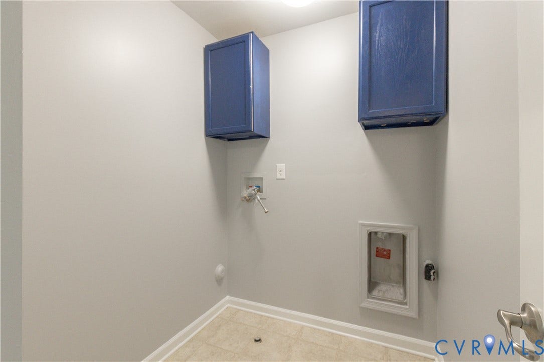 12814 Bailey Hill Court, Bayhill Pointe, Midlothian, VA 23112 Laundry area featuring neutral wall paint, two blue wall-mounted storage cabinets, and tiled flooring