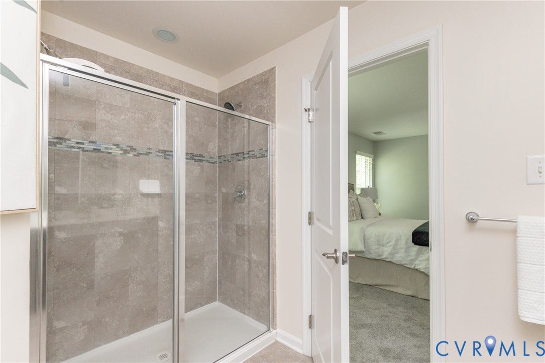 12814 Bailey Hill Court, Bayhill Pointe, Midlothian, VA 23112 Glass-enclosed shower with gray tiled walls, decorative accent tile band, and recessed lighting