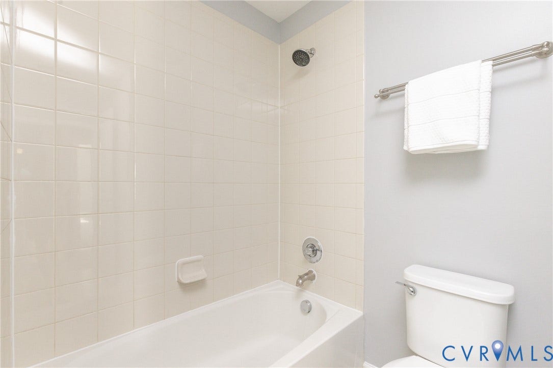 12814 Bailey Hill Court, Bayhill Pointe, Midlothian, VA 23112 Bathtub with white tile surround, brushed nickel fixtures, and a wall-mounted showerhead