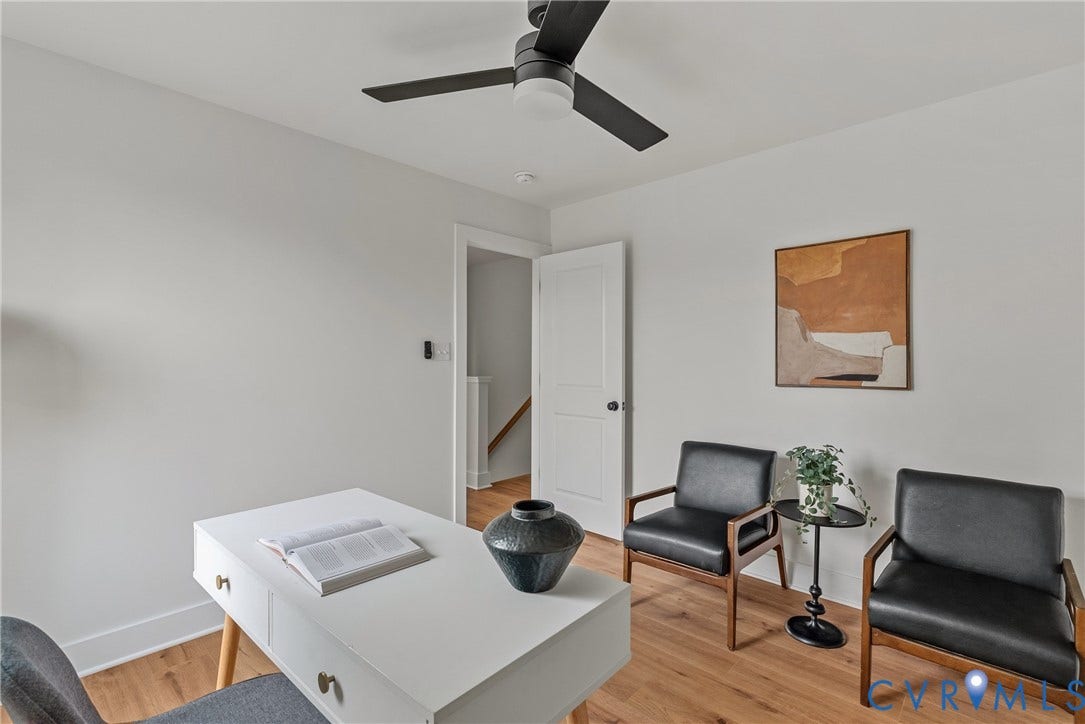 Recessed lighting, wood-finish flooring, white paneled door, and a ceiling fan with light