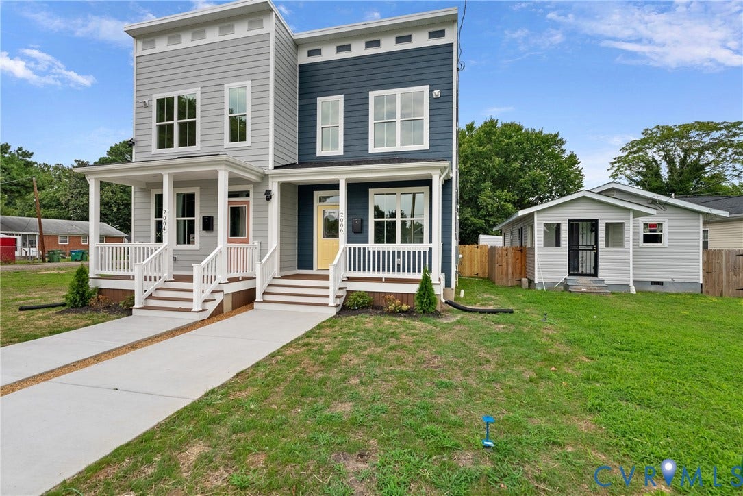 Two-story modern duplex with contrasting siding and individual covered front porches