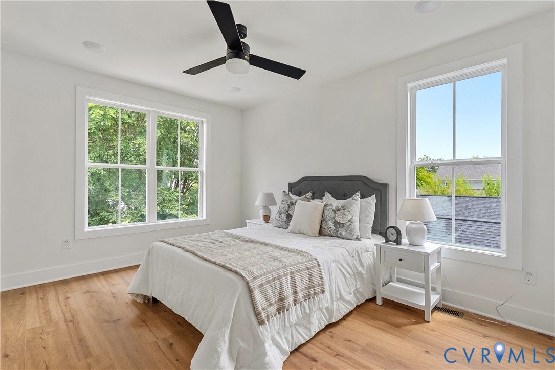White walls with wood-finish flooring, recessed lighting, and a ceiling fan