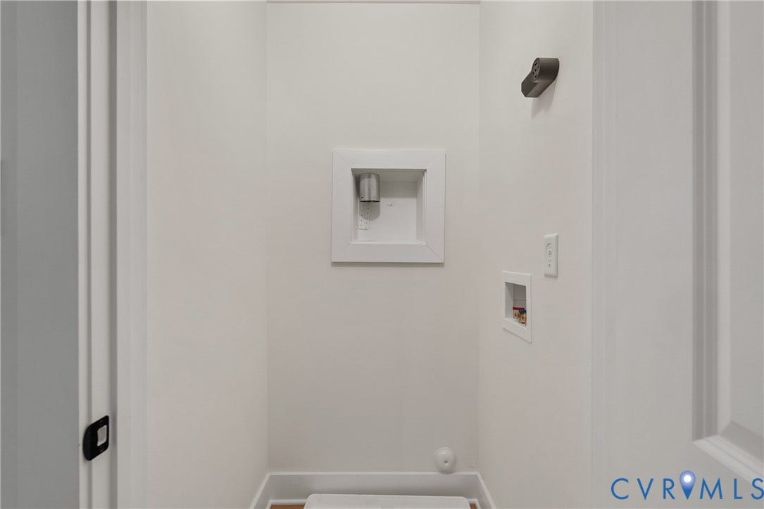 Dedicated laundry area with recessed water hookups and electrical outlet