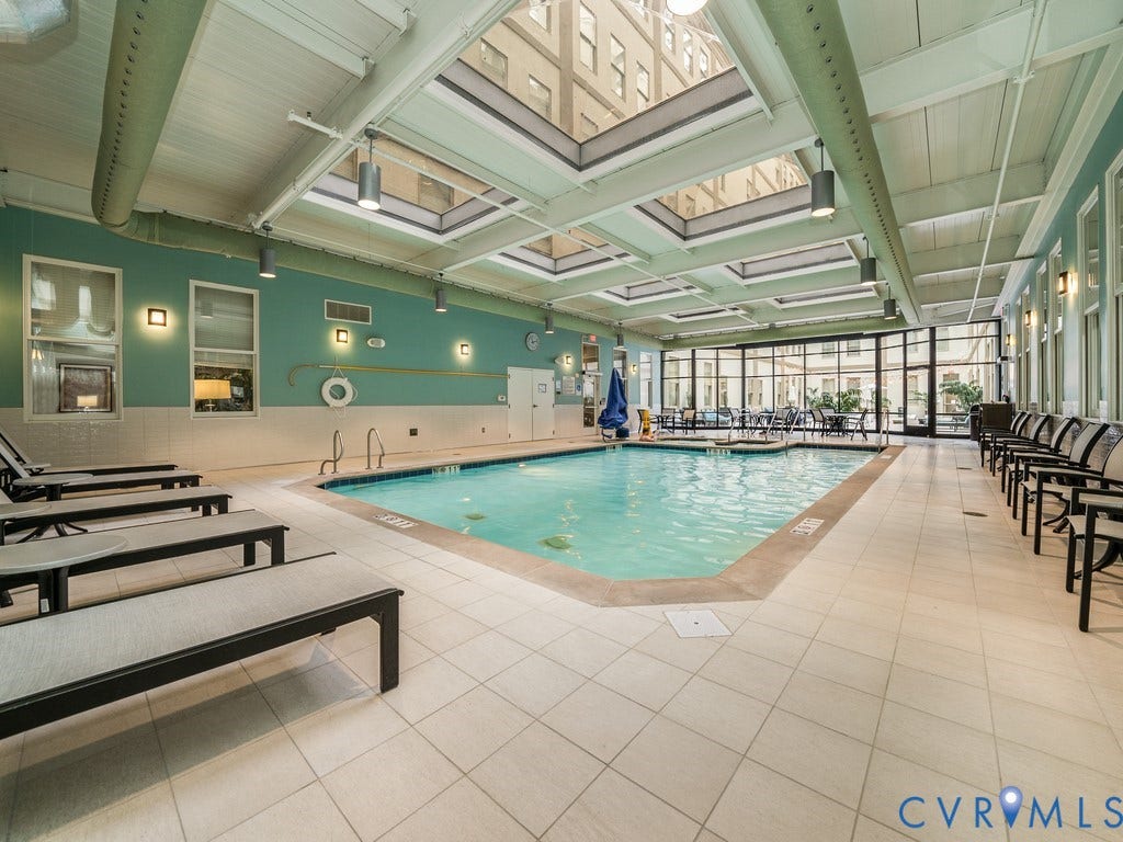 230 N 6th Street, #U325, Richmond, VA 23219 Indoor swimming pool with skylights, large windows, and perimeter track lighting