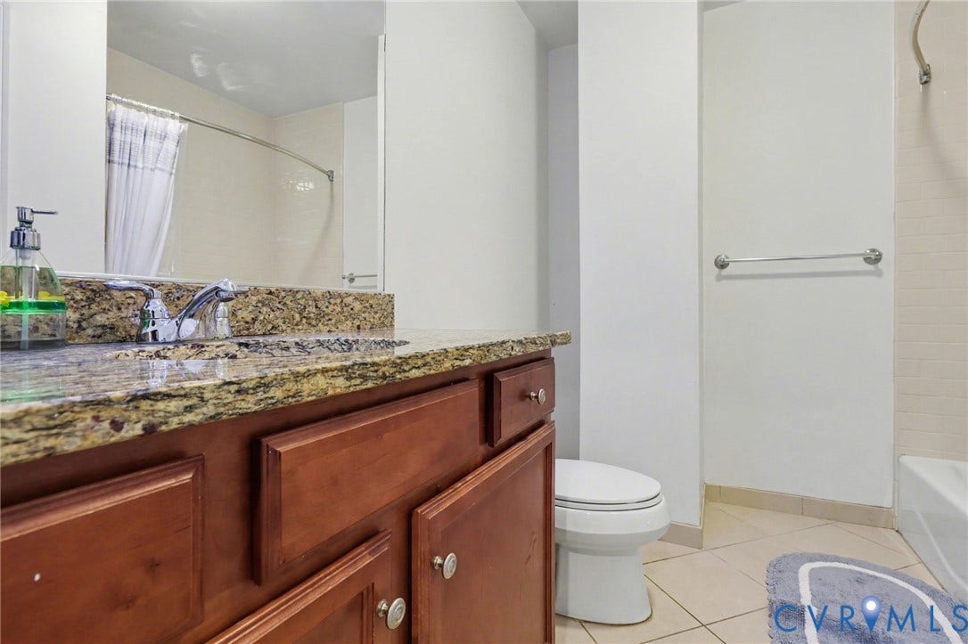 230 N 6th Street, #U325, Richmond, VA 23219 Bathroom vanity featuring a granite countertop with an undermount sink and chrome faucet