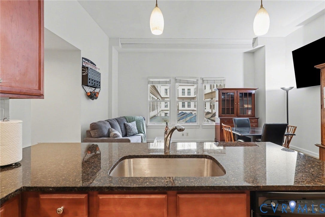 230 N 6th Street, #U325, Richmond, VA 23219 Kitchen island with a stainless steel sink and a gooseneck faucet