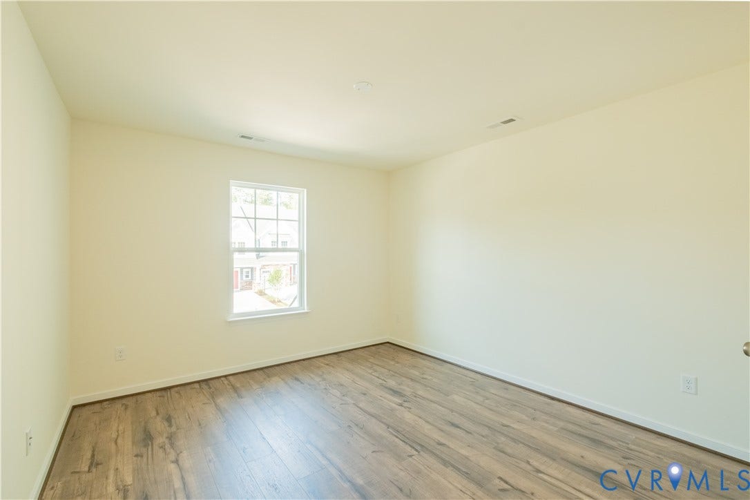 18429 Palisades Court, Chesterfield, VA 23120 Spacious room featuring wood-finish flooring, light-toned walls, a single window with white trim, and recessed ceiling lighting