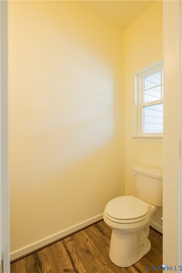 18429 Palisades Court, Chesterfield, VA 23120 Water closet featuring wood-finish flooring, a white toilet, and a window with white trim