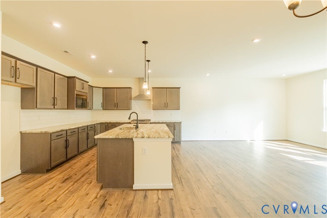 18429 Palisades Court, Chesterfield, VA 23120 Open-concept kitchen and living area featuring wood-finish flooring, recessed lighting, and a kitchen island with pendant lights