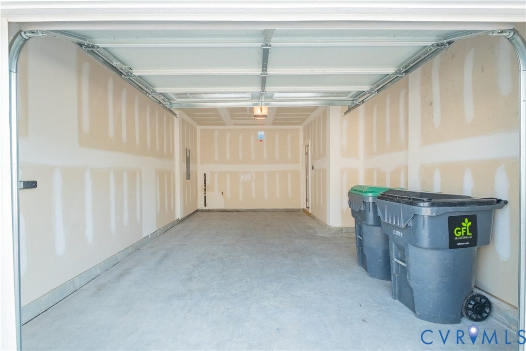 18429 Palisades Court, Chesterfield, VA 23120 Spacious garage with concrete flooring, unfinished drywall, and exposed ceiling joists