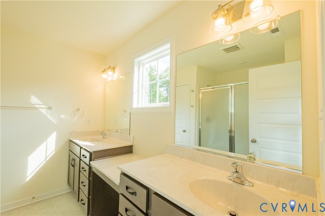 18429 Palisades Court, Chesterfield, VA 23120 Double vanity featuring undermount sinks, white countertops, and dark cabinetry