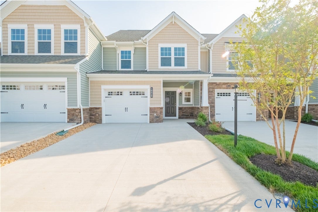 18429 Palisades Court, Chesterfield, VA 23120 Modern townhome exterior featuring light-toned siding, stone accents, and white garage doors with decorative hardware
