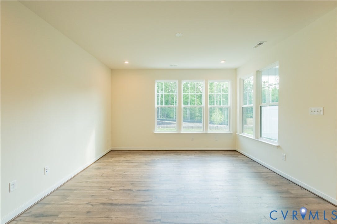 18429 Palisades Court, Chesterfield, VA 23120 Spacious room featuring multiple large windows, wood-finish flooring, recessed lighting, and light-toned wall paint