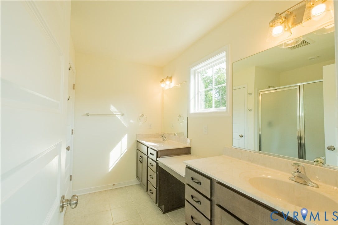 18429 Palisades Court, Chesterfield, VA 23120 Bathroom with two vanity sinks, a built-in makeup vanity, a window, and a glass-enclosed shower