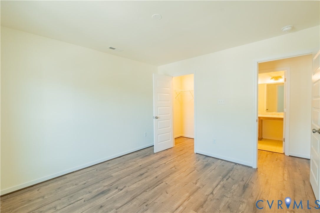 18429 Palisades Court, Chesterfield, VA 23120 Spacious room featuring wood-finish flooring, light-colored walls, and a closet with shelving
