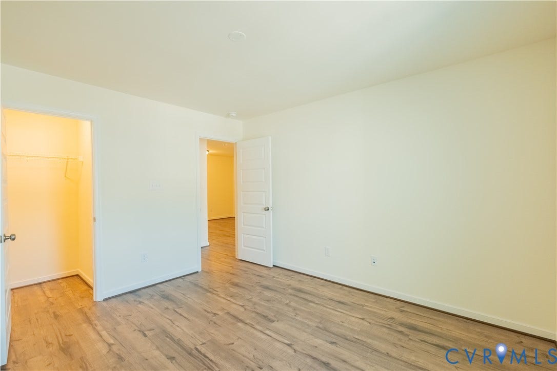 18429 Palisades Court, Chesterfield, VA 23120 Room featuring wood-finish flooring, white baseboards, and neutral wall paint