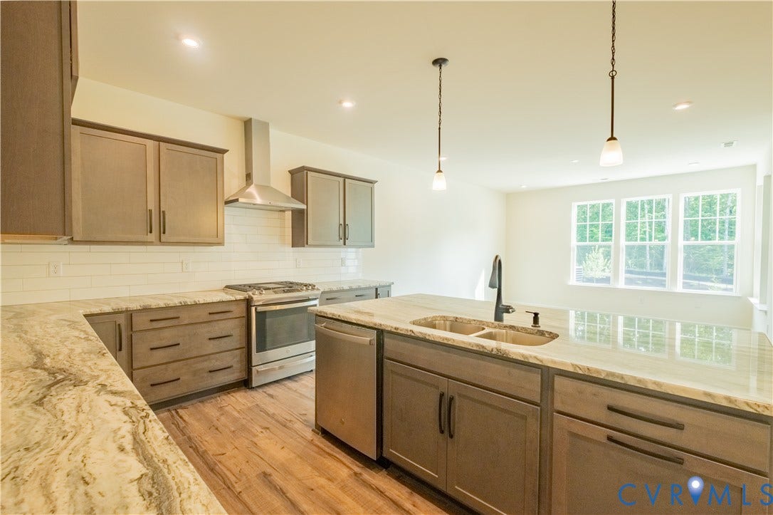 18429 Palisades Court, Chesterfield, VA 23120 Contemporary kitchen featuring an expansive center island with dual basin sink and pendant lighting
