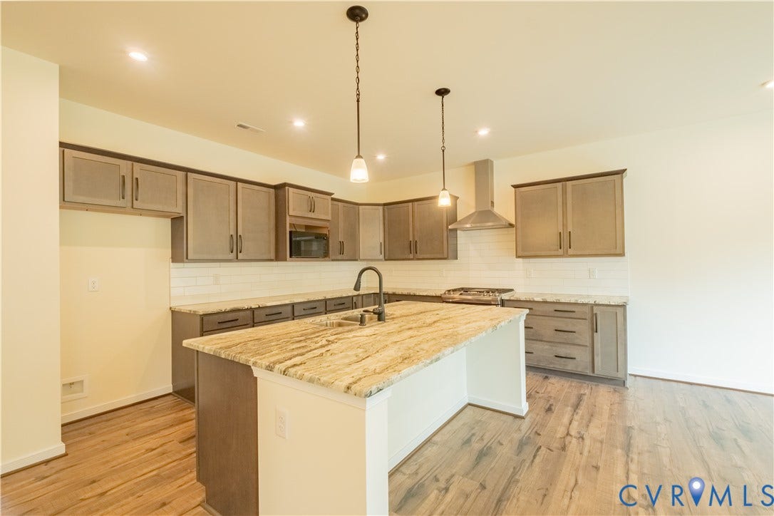 18429 Palisades Court, Chesterfield, VA 23120 Kitchen featuring a central island with a multi-toned countertop, wood-finish flooring, recessed lighting, and pendant lights