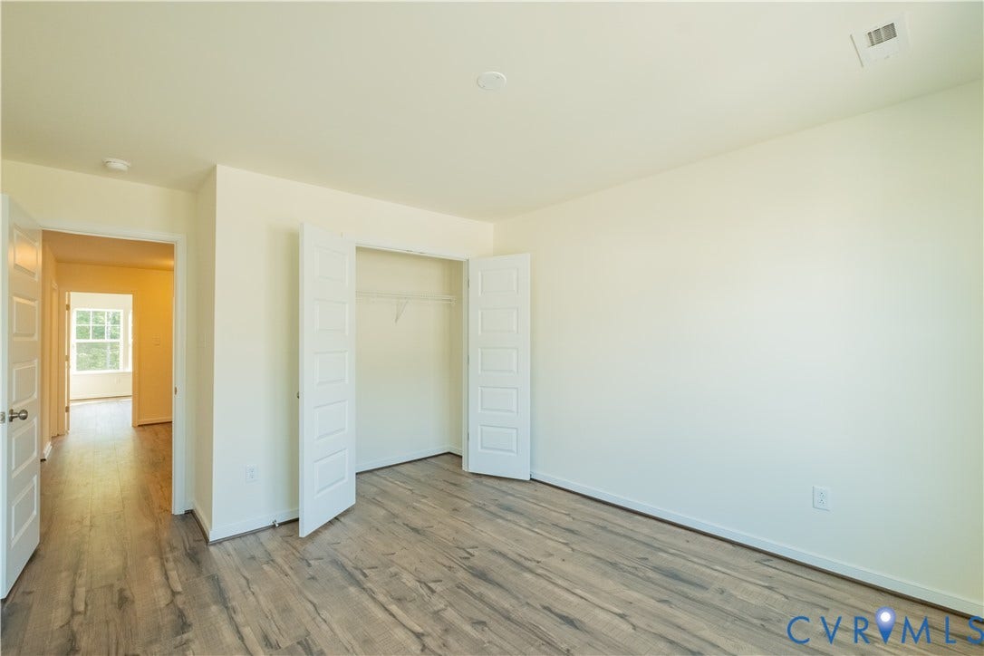 18429 Palisades Court, Chesterfield, VA 23120 Interior room featuring wood-finish flooring, white baseboards, and a neutral wall color