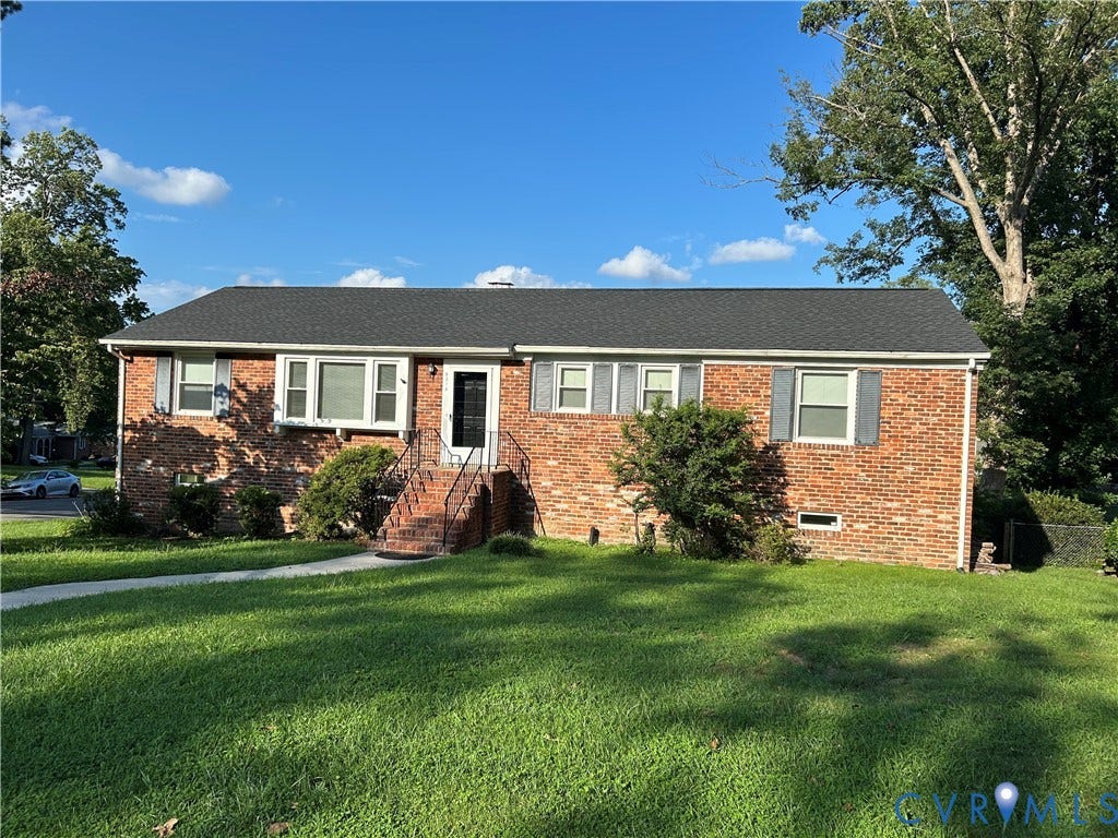 9314 Newhall Road, Henrico, VA 23229 Brick exterior with dark gray shutters, a black shingle roof, and a front entry featuring a wrought iron railing