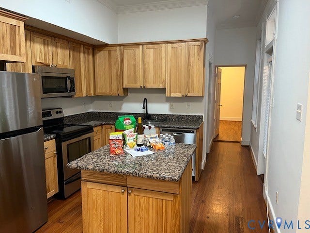220 W Marshall Street, Jackson Ward, Richmond, VA 23220 Kitchen featuring wood cabinetry, stainless steel appliances, dark speckled countertops, a center island, and wood-finish flooring
