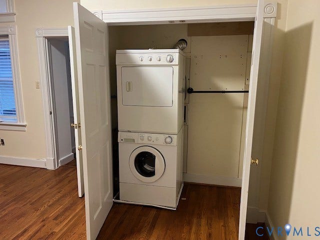 220 W Marshall Street, Jackson Ward, Richmond, VA 23220 Dedicated laundry closet featuring a stacked washer and dryer, wood-finish flooring, and a hanging rod