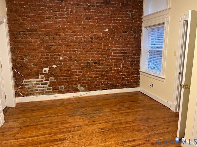 222 W Marshall Street, Jackson Ward, Richmond, VA 23220 Exposed brick accent wall with wood-finish flooring