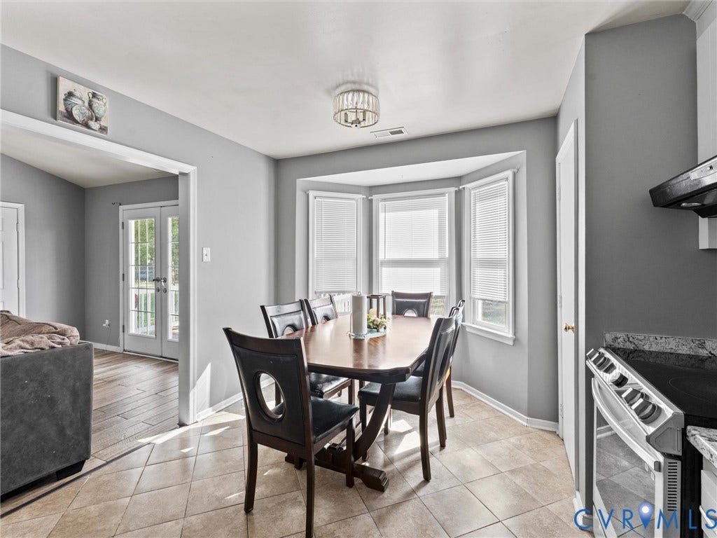 7323 Pineleaf Drive, Chesterfield, VA 23234 Dining area featuring ceramic tile flooring, a bay window with blinds, and an overhead lighting fixture