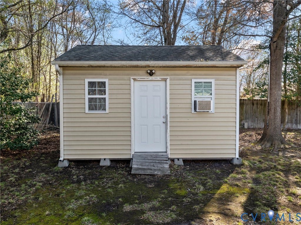 7323 Pineleaf Drive, Chesterfield, VA 23234 Exterior storage shed with light beige siding and a dark shingle roof