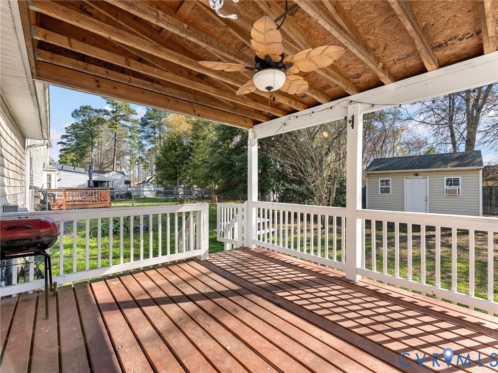 7323 Pineleaf Drive, Chesterfield, VA 23234 Expansive covered deck featuring rich wood-finish flooring, white balustrade railing, and an overhead ceiling fan