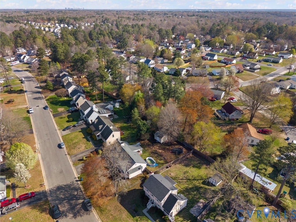7323 Pineleaf Drive, Chesterfield, VA 23234 Aerial perspective showcasing a residential area characterized by detached homes with gabled roofs, mature trees, and paved streets