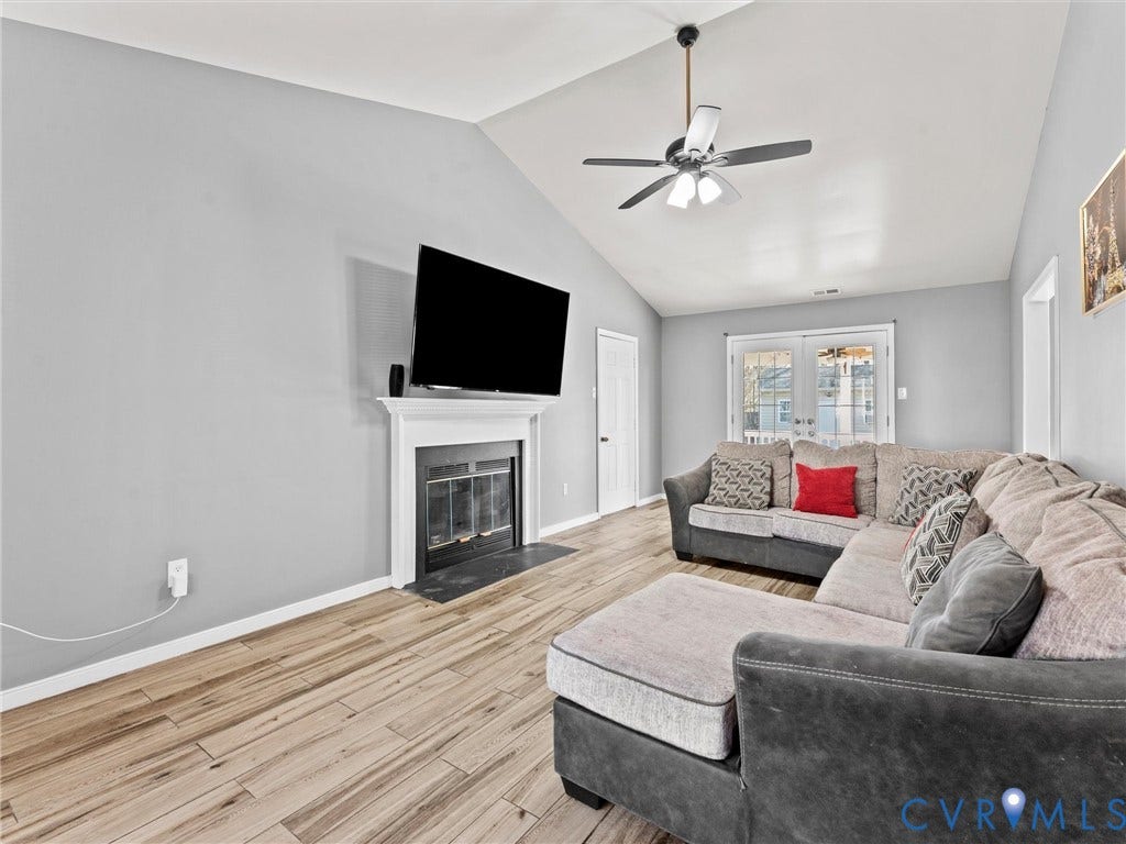 7323 Pineleaf Drive, Chesterfield, VA 23234 Spacious living area featuring a vaulted ceiling and wood-finish flooring